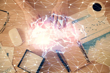 Double exposure of man's hands typing over computer keyboard and brain hologram drawing. Top view. Ai and data technology concept.の写真素材