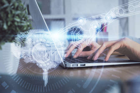 Double exposure of woman hands working on computer and brain hologram drawing. Ai concept.の写真素材