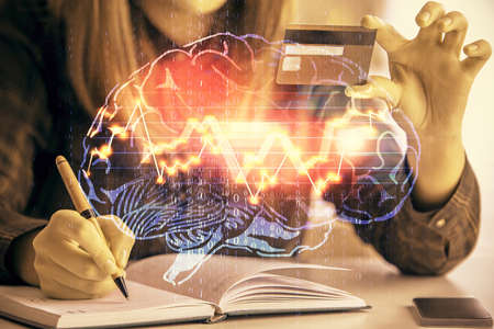 Double exposure of woman on-line shopping holding a credit card and brain hologram drawing. Data E-commerce concept.の写真素材