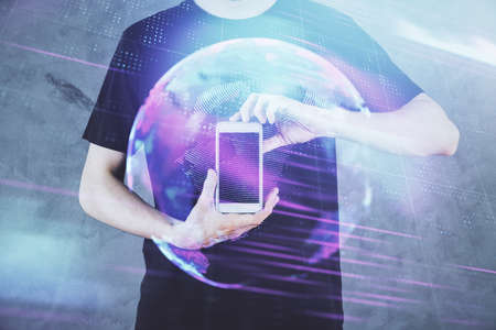 Double exposure of man's hands holding and using a digital device and tech theme hologram drawing. Technology concept.の写真素材