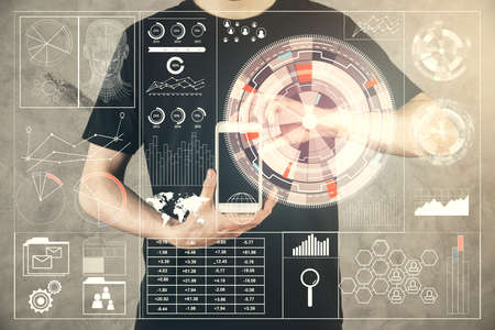 Double exposure of man's hand holding and using a digital device and data theme hologram drawing. Technology concept.の写真素材