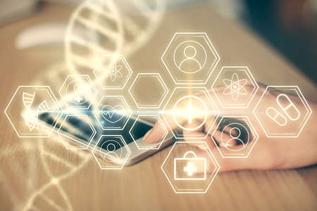 Double exposure of DNA sketch hologram and woman holding and using a mobile device. Education concept.の写真素材