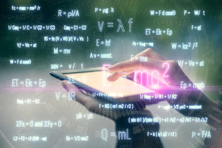 Double exposure of formulas sketch hologram and woman holding and using a mobile device. Education concept.の写真素材