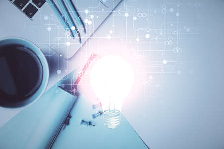 Bulb drawing over computer on the desktop background. Top view. Double exposure. Idea concept.の写真素材