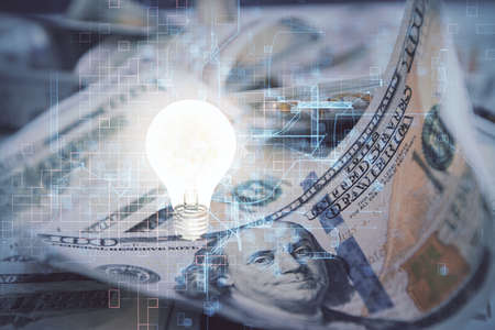 Double exposure of light bulb drawing over usa dollars bill background. Concept of idea.の写真素材