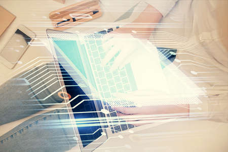 Double exposure of woman hands working on computer and data theme hologram drawing. Top View. Technology concept.の写真素材