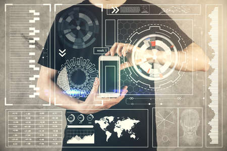 Double exposure of man's hand holding and using a digital device and data theme hologram drawing....