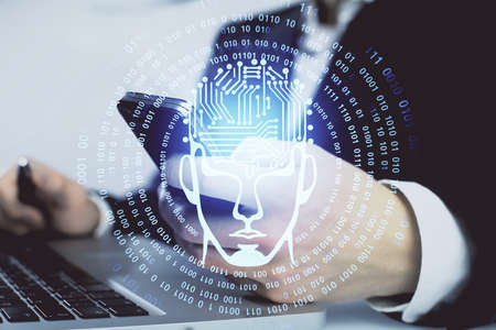 Double exposure of man's hand holding and using a digital device and brain hologram drawing. Data...
