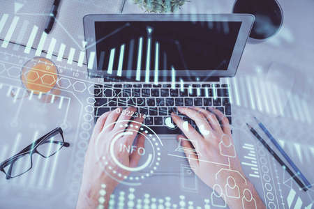 Double exposure of man's hands typing over computer keyboard and tech theme hologram drawing. Top view. Technology concept.の写真素材