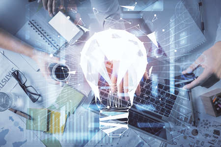 Double exposure of man and woman working together and bulb drawing. Computer background. Top View. Idea concept.の写真素材