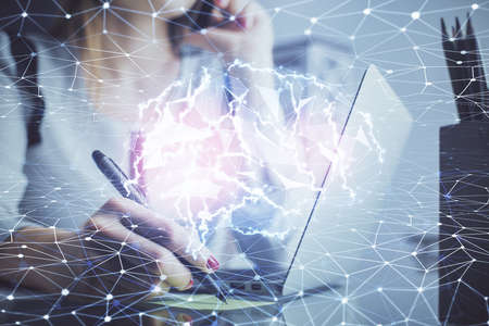 Multi exposure of woman hands working on computer and human brain hologram drawing. Ai tech concept.の写真素材