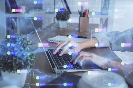 Double exposure of woman hands working on computer and data theme hologram drawing. Tech concept.