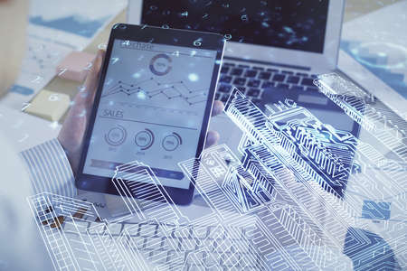 Double exposure of man's hands holding and using a digital device and city drawing.の写真素材