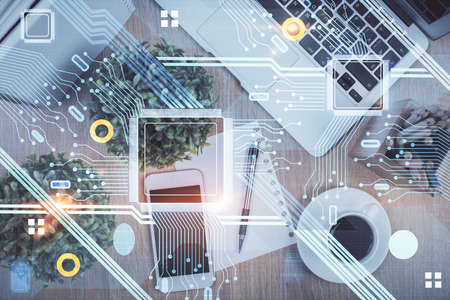 Double exposure of technology theme drawing over work table desktop. Top view. Global data analysis...