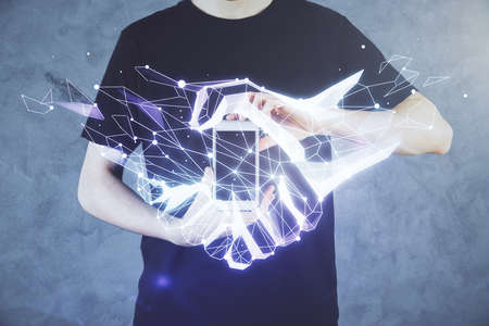 Double exposure of man's hands holding and using a digital device and handshake drawing. Partnership concept.の写真素材
