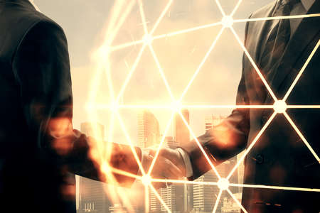Double exposure of social network theme hologram and handshake of two men.