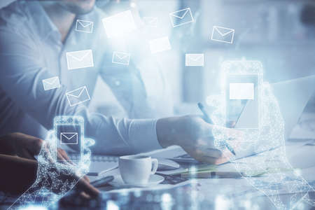 Double exposure of man and woman working together and envelop hologram drawing. e-mail concept....