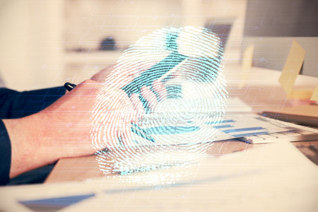Double exposure of man's hands holding and using a digital device and fingerprint hologram drawing. Security concept.の写真素材