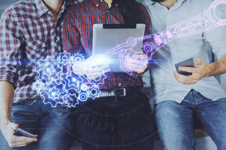 Double exposure of data theme hologram drawing and man and woman working together holding and using a mobile device.の写真素材