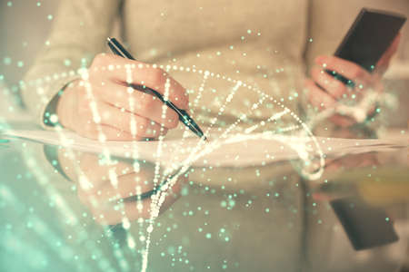 Double exposure of DNA sketch hologram and woman holding and using a mobile device. Education...