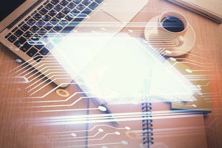 Double exposure of data theme drawing hologram over topview work table background with computer....