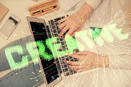 Double exposure of woman hands working on computer and creative hologram drawing. Top View. Start up...
