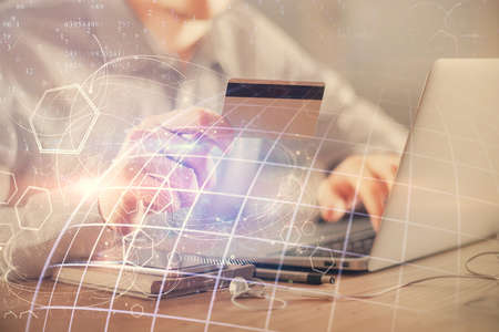 Double exposure of man hands holding a credit card and world map drawing. International Internet...