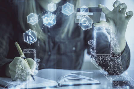 Multi exposure of woman on-line shopping holding a credit card and tech theme drawing. Technology concept.の写真素材