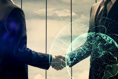 Double exposure of social network theme hologram and handshake of two men.
