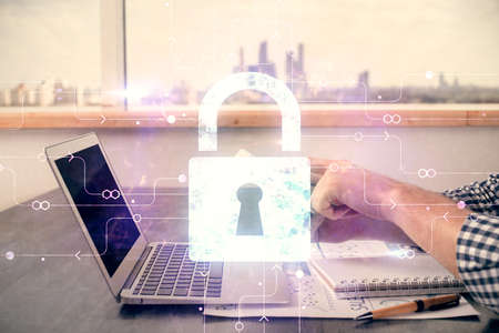 Multi exposure of man's hands holding and using a digital device and lock drawing. Security concept.