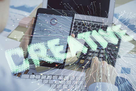 Double exposure of man's hands holding and using a mobile device and creative hologram drawing.