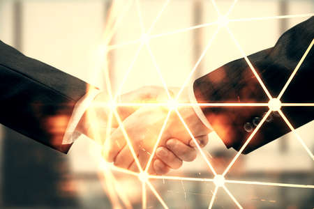 Double exposure of social network theme hologram and handshake of two men.の写真素材