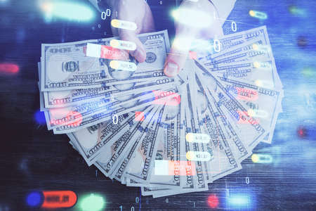 Multi exposure of technology drawing hologram and us dollars bills and man hands. Data conceptの写真素材