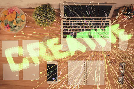 Start up theme drawing over computer on the desktop background. Top view. Double exposure. Brainstorm concept.の写真素材