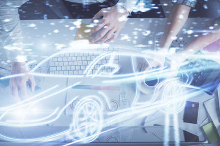 Double exposure of man and woman working together and a car drawing. Computer background. Top View. Autopilot concept.の写真素材
