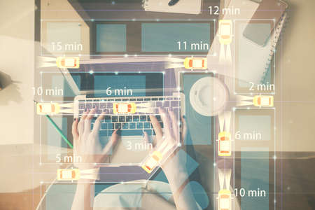 Double exposure of woman hands working on computer and car hologram drawing. Top View. Auto pilot...