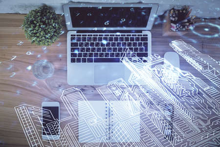 City drawing over computer on the desktop background. Top view. Double exposure. Smart home concept.の写真素材