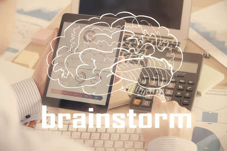 Double exposure of man's hands holding and using a mobile device and creative hologram drawing.