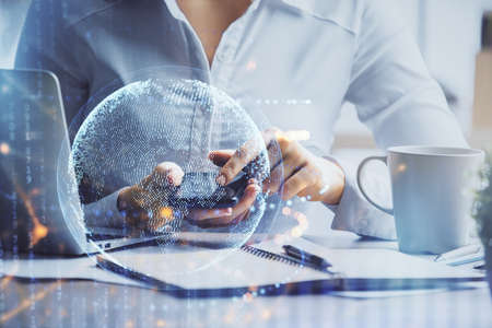 Double exposure of map sketch hologram and woman holding and using a mobile device.の写真素材