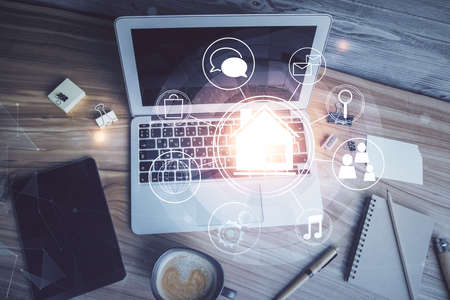 City drawing over computer on the desktop background. Top view. Double exposure. Smart home concept.の写真素材