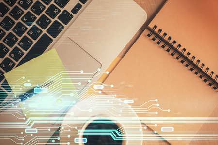 Double exposure of data theme drawing hologram over topview work table background with computer....