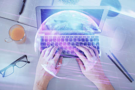 Double exposure of man's hands typing over computer keyboard and tech theme hologram drawing. Top view. Technology concept.の写真素材