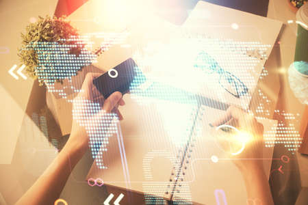 Double exposure of woman on-line shopping holding a credit card and world map hologram drawing....