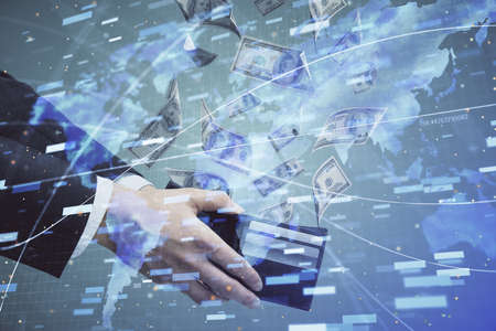 Multi exposure of technology drawing hologram and us dollars bills and man hands. Data concept