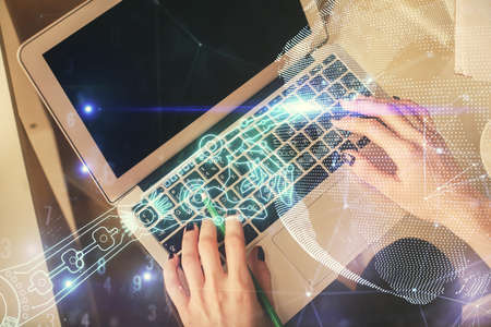 Double exposure of woman hands working on computer and tech theme hologram drawing. Top View....