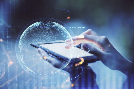 Double exposure of map sketch hologram and woman holding and using a mobile device.の写真素材