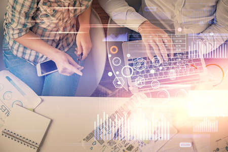 Double exposure of man and woman working together and data theme hologram drawing. Computer...