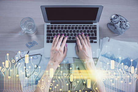 Double exposure of woman hands working on computer and data theme hologram drawing. Top View....