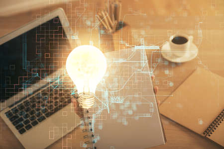 Double exposure of woman hands typing on computer and light bulb drawing. Idea concept.