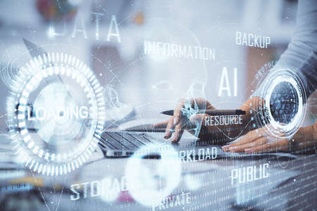 Double exposure of woman hands working on computer and data theme hologram drawing. Tech concept.の写真素材
